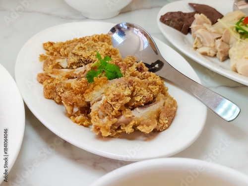 Delicious crispy slice deep-fried chicken in a white dish at the restaurant.