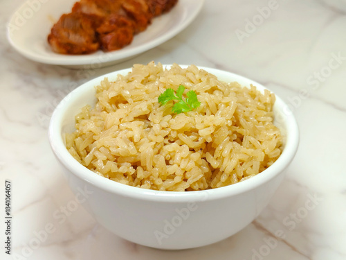 Steamed rice in a white bowl served with chicken. Thai delicious street food.
