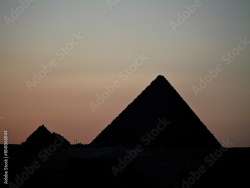 Cairo,Egypt - December 5, 2025: Silhouette of Menkaure's Pyramid at dawn

