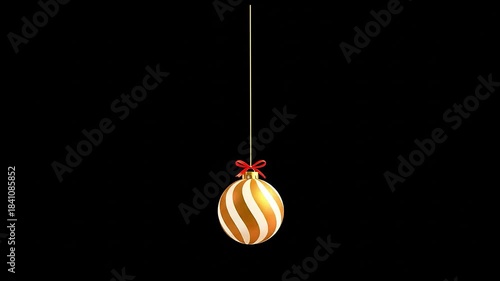 A shiny gold Christmas ornament ball rotating smoothly, hanging from a thin gold string and decorated with a small elegant ribbon. Perfect for holiday themes, Christmas, New Year, Party, etc