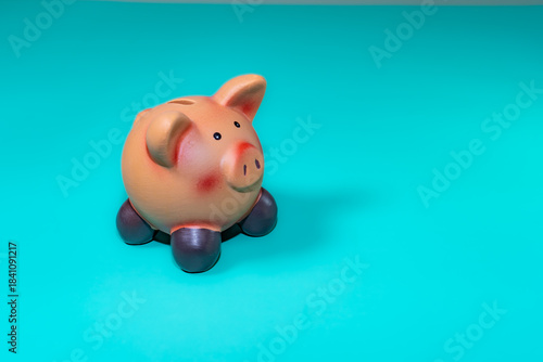 A piggy bank, a symbol of savings, set against a solid backdrop, evokes financial security amid economic downturns.