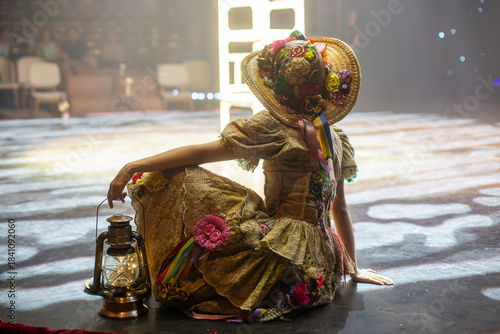 Backstage Wonder: Woman in Costume Gazes Toward the Circus Lights