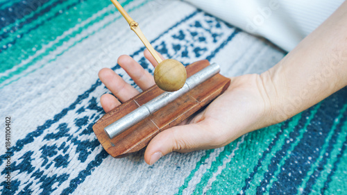 Hand holding a single chime for sound healing and meditating