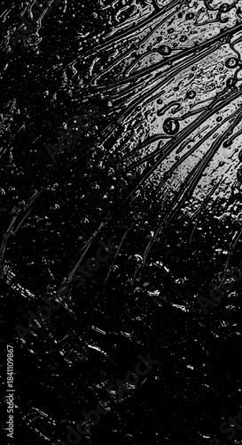 Intricate, dark abstract design with flowing streaks and textured details.