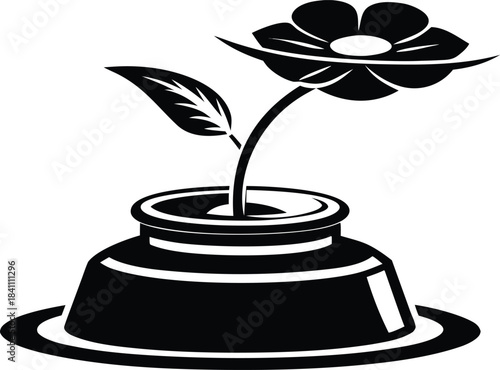 Black and white illustration of a single flower in an inkwell