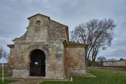 Visigothic Basilica of San Juan de Banos in Cerrato with a stone structure and gabled roof in a historic setting