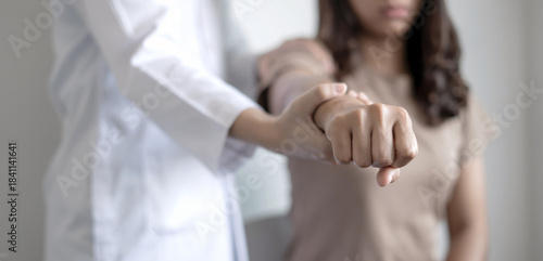 Female physiotherapists provide physical assistance to woman patients with shoulder injuries massaging their shoulders for muscle recovery in the rehabilitation center. Physiotherapy concepts