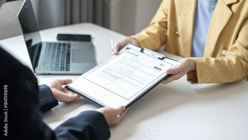 Business people hold a resume and talk to job applicants for job interviews about careers and Their personal history in the company. Recruitment concepts