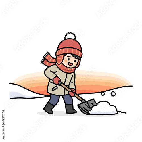 Young boy shoveling snow from driveway during sunset in winter  