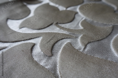 Closeup of beige and silver single damask jacquard fabric