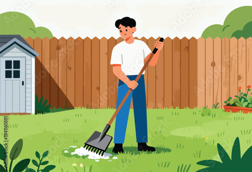 A man rakes on a bright day in a grassy backyard near a wooden fence and shed