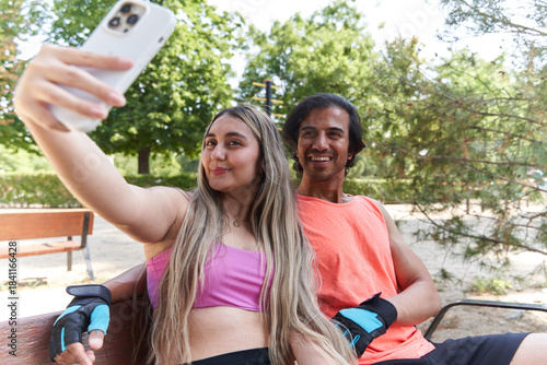 Happy couple taking selfie after workout in park