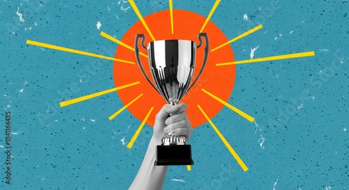 Hand holding a silver trophy against a bright orange sunburst on a textured blue background