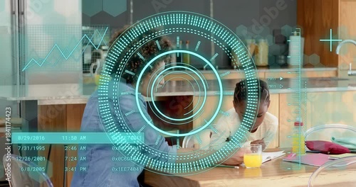 Mother reaching notebook and guiding daughter writing homework with pencil in kitchen, HUD rings