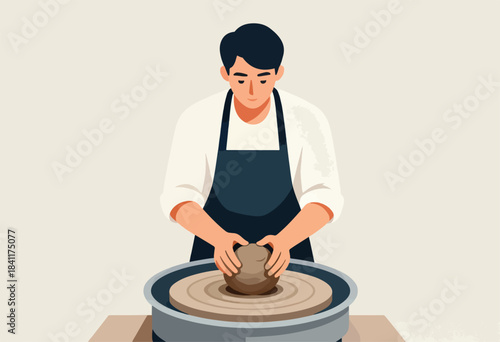 A person in a white shirt and navy apron works on a pottery wheel, shaping a ball of clay