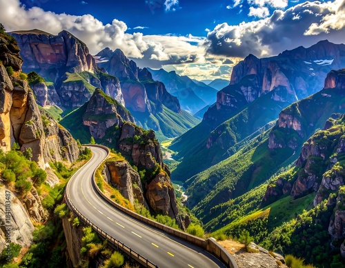 Winding mountain road through a lush green valley, under a bright sky