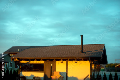 rooftop and chimney at the sunset