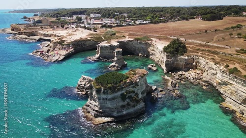 Aerial view of Faraglioni di Sant Andrea cliffs in southern Italy, Puglia region, Salento peninsula on the Adriatic sea coast	