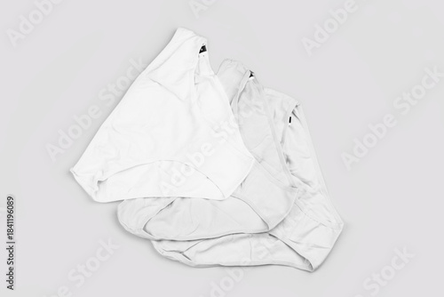 Multicolored women's underpants on a pink background top view black and white photo