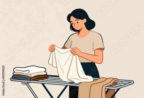 An illustration shows a woman folding laundry, standing at a folding rack. A pile of folded clothes is on the rack