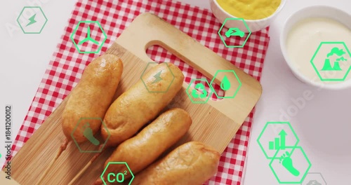 Green hex icons appearing at edges moving over four skewered sausages on board showing eco impact