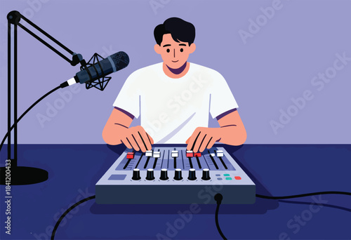 A man in a white tee, at a sound mixing board, with a microphone angled down towards it