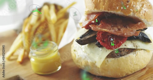 Faint spark appearing then green icons drifting over cheeseburger fries and jar highlighting flavor
