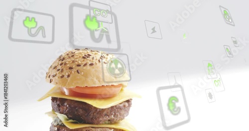 Top bun appearing, camera shifting, revealing cheeseburger while eco-icons floating, showing green