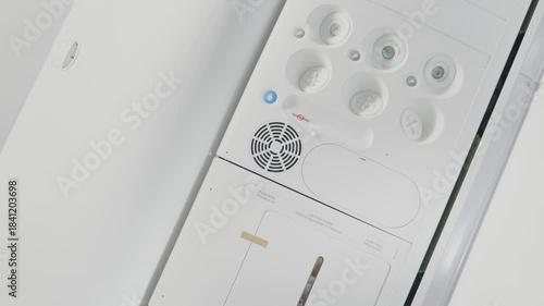 Close-up view of an airplane overhead console with air vents and light controls