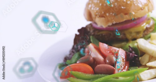 Drifting teal hex icons initiating camera panning, revealing plated hamburger and fries for menu