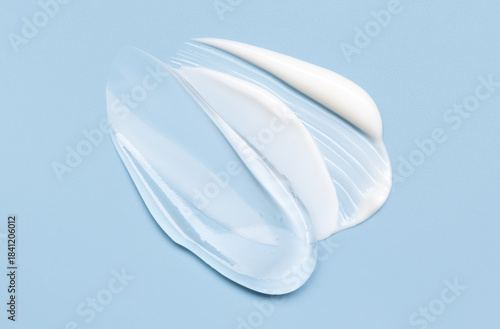Close-up of cosmetic smear of creamy texture on blue background