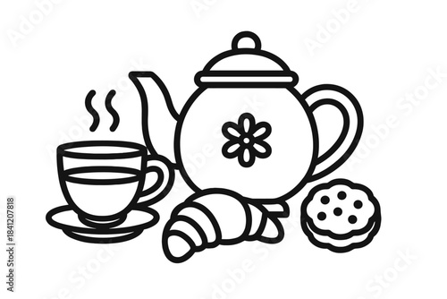 Hot tea with croissant and cookies on a table during breakfast time