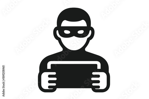 Person in a mask holds a tablet while looking at the screen in a dark environment at night