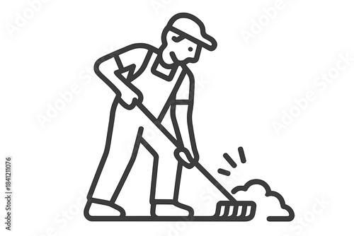 Man working with a rake to move soil at a construction site during day time in an outdoor setting