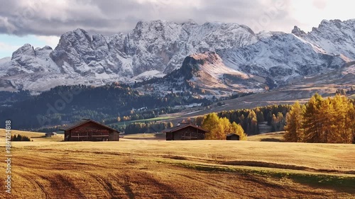 Place to live peaceful life, wooden houses. Alpe di Siusi, Seiser Alm, aerial view of majestic dolomites, mountains background.