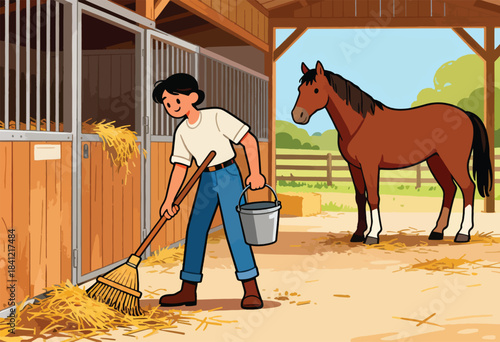 A person sweeps hay in a stable with a brown horse standing nearby. Blue sky, hay bales