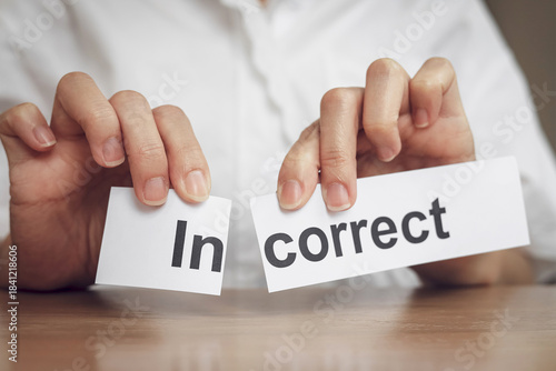 Wallpaper Mural A close-up view of hand tearing the word In from Correct to change its meaning. concept of monitoring for non-compliance with regulations, and making the right decisions. Torontodigital.ca