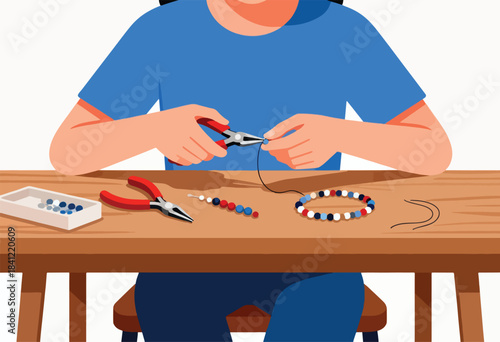 A person in a blue shirt is crafting a beaded bracelet, using pliers at a wooden table