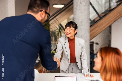 Professional Team Meeting Highlighting Diversity and Collaboration in a Modern Office