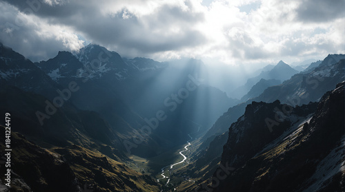 Majestic Mountain Vista: A breathtaking panoramic view of towering mountain peaks, with the sun's rays piercing through the clouds to illuminate a winding river below.