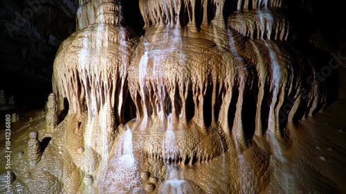 Timelapse of Water Dripping and Flowing Over Majestic Cave Formations. Earthy Brown Stalactites and Stalagmites in a Mysterious Underground Geological Wonder.
