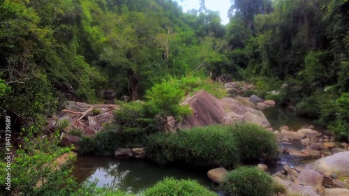 Stone blocks of a mountain river.

Baho Falls in Vietnam near Nha Trang. Cascades of a mountain river that turn into waterfalls on the lower rapids. Drone flight. 