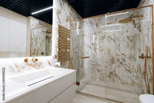 Opulent washroom featuring stone walls and reflective mirror