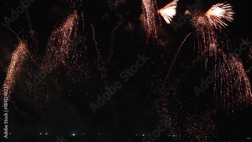 Amazing real beautiful colorful fireworks background on celebration night event for happy new year party, Abstract Multi color golden firework in the night sky