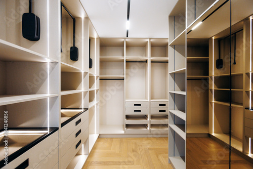 dressing closet with mirror panels and integrated lighting