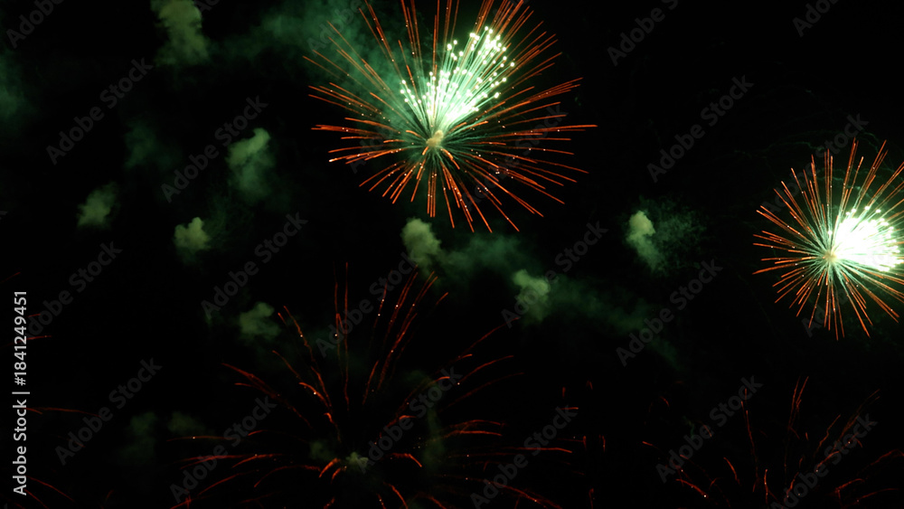 Fototapeta premium Amazing real beautiful colorful fireworks background on celebration night event for happy new year party, Abstract Multi color golden firework in the night sky