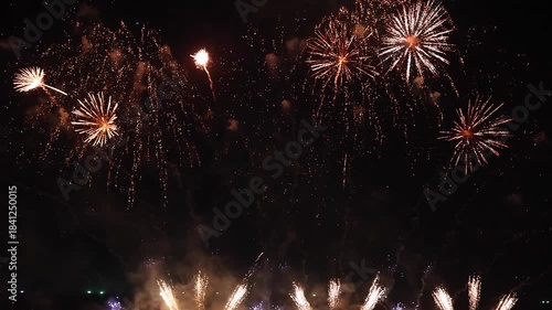 Amazing real beautiful colorful fireworks background on celebration night event for happy new year party, Abstract Multi color golden firework in the night sky