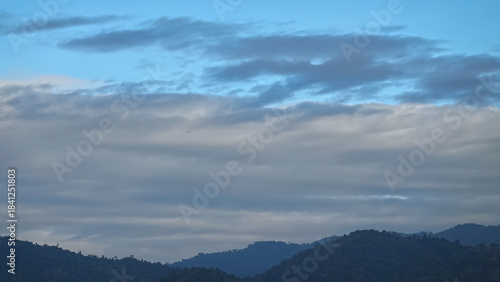 Evening blue sky clouds mountains range landscape.