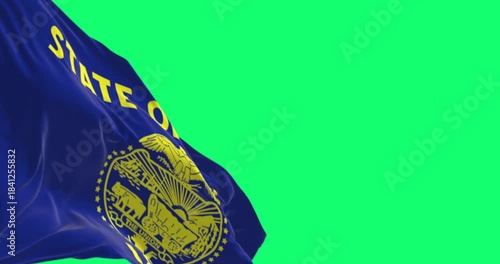 Oregon state flag waving in the wind isolated on green background