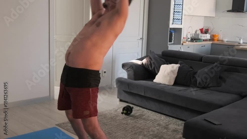 active home workout, white male doing lively cardio at home, man performing highenergy household cardio routine with enthusiasm, an energetic white man engaging in vigorous home cardio exercises